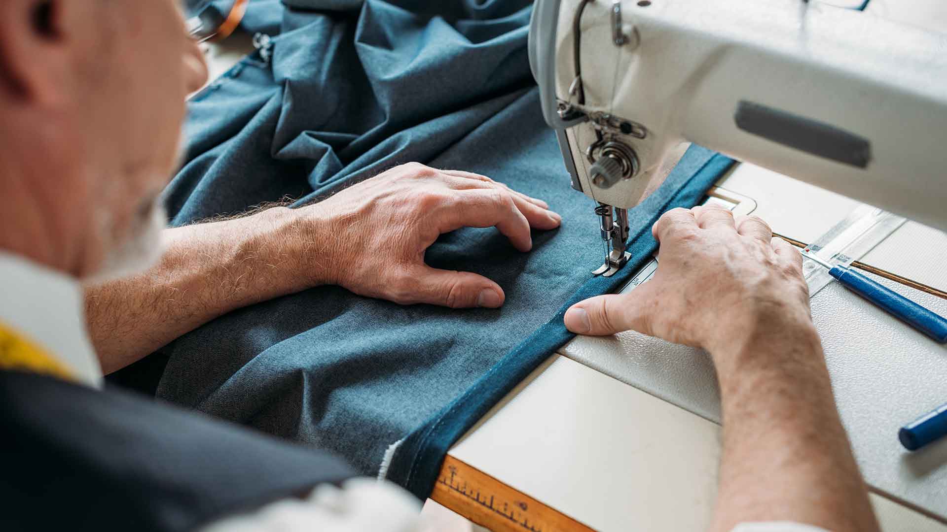 A man working on a sewing machine.